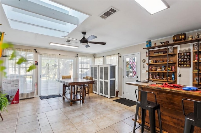 kitchen with light tile patterned floors and ceiling fan