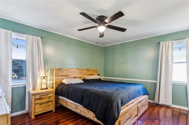 bedroom with dark hardwood / wood-style flooring and ceiling fan