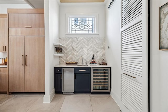 bar with sink, wine cooler, ornamental molding, decorative backsplash, and light brown cabinets