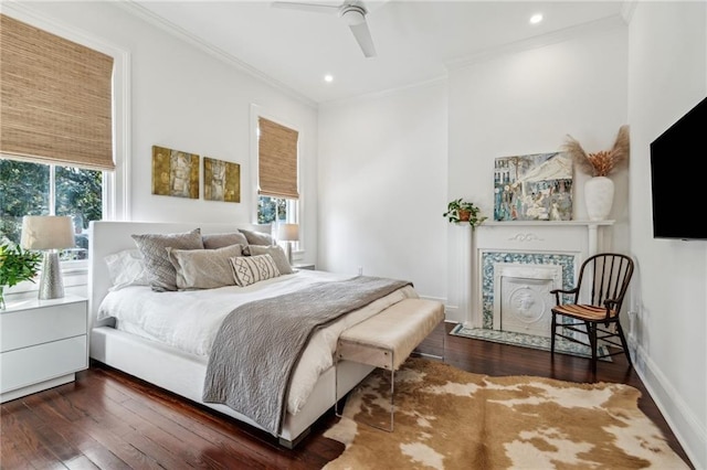 bedroom with dark wood-type flooring, ceiling fan, and ornamental molding