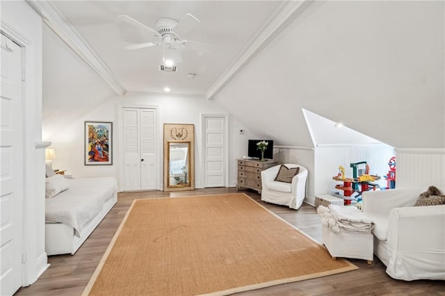 bedroom with ceiling fan, lofted ceiling, and wood-type flooring