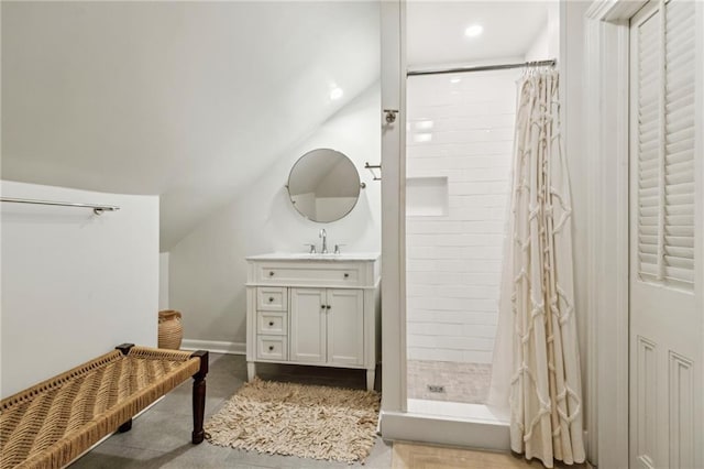 bathroom with vanity, lofted ceiling, and a shower with curtain