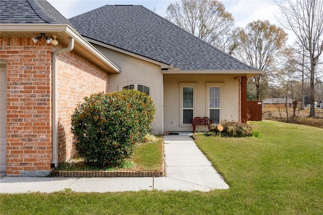 entrance to property featuring a yard