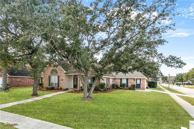 ranch-style home featuring a front yard