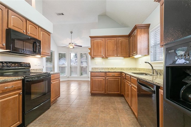 kitchen with light tile patterned flooring, lofted ceiling, sink, and black appliances