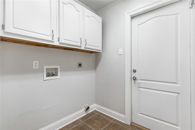 laundry area featuring cabinets, hookup for a washing machine, hookup for an electric dryer, and dark tile patterned flooring