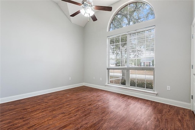 empty room featuring hardwood / wood-style flooring, high vaulted ceiling, and ceiling fan