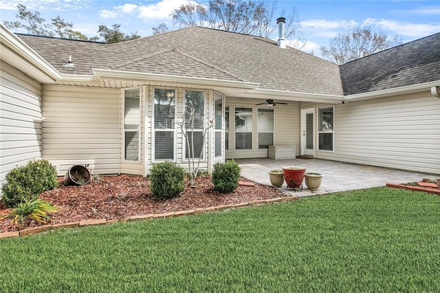 back of house featuring a lawn and a patio area