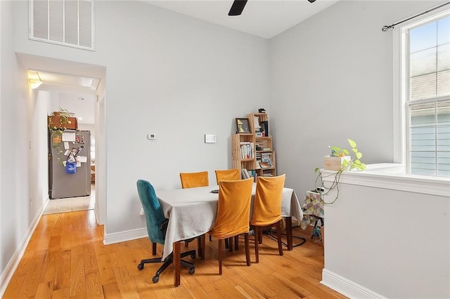 dining room with ceiling fan and light hardwood / wood-style floors