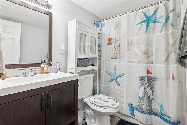 bathroom featuring walk in shower, vanity, and toilet