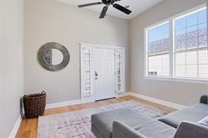 living room featuring hardwood / wood-style flooring and ceiling fan