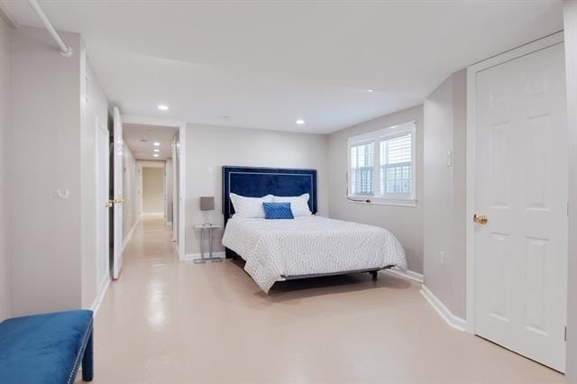 bedroom featuring concrete flooring