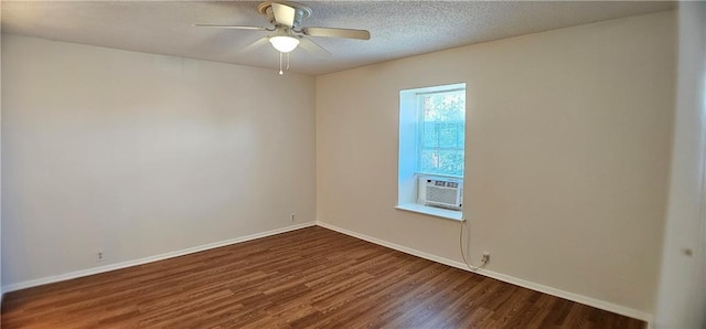 empty room with ceiling fan, a textured ceiling, wood finished floors, cooling unit, and baseboards