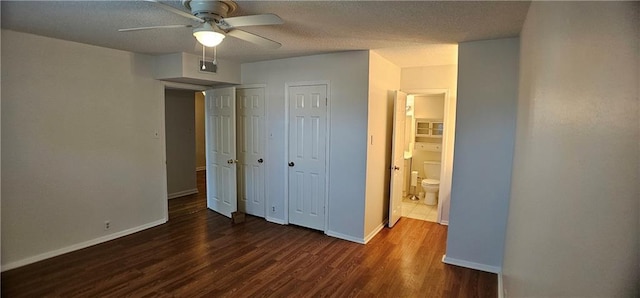 unfurnished bedroom with baseboards, visible vents, a ceiling fan, dark wood-style floors, and a textured ceiling