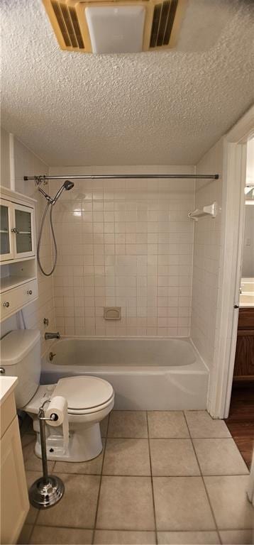 bathroom with toilet, a textured ceiling, washtub / shower combination, and vanity