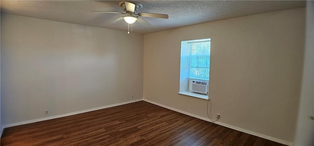 spare room featuring dark wood-style floors, a textured ceiling, baseboards, and a ceiling fan