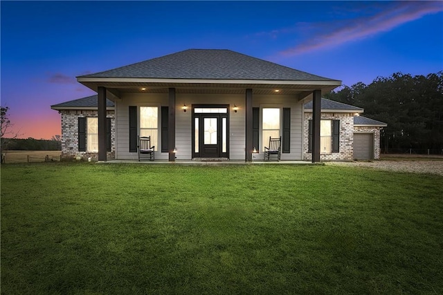 71078 Troy Spears Rd, Kentwood, LA 70444 - rear view of property with a lawn, a garage, covered porch, roof with shingles, and brick siding