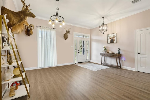 71078 Troy Spears Rd, Kentwood, LA 70444 - foyer entrance featuring wood finished floors, a notable chandelier, crown molding, and visible vents