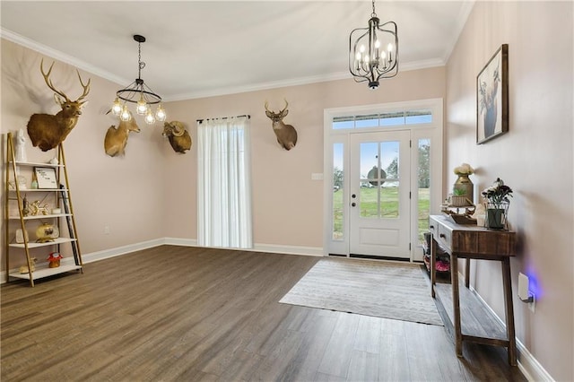 entrance foyer with crown molding, dark hardwood / wood-style floors, and a chandelier