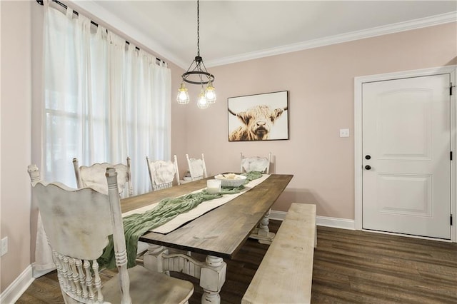 dining area featuring crown molding, an inviting chandelier, and dark wood-type flooring