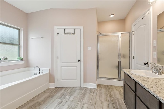 bathroom with vanity and plus walk in shower