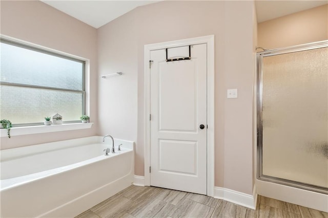 bathroom with separate shower and tub