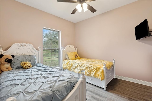 bedroom with wood-type flooring and ceiling fan