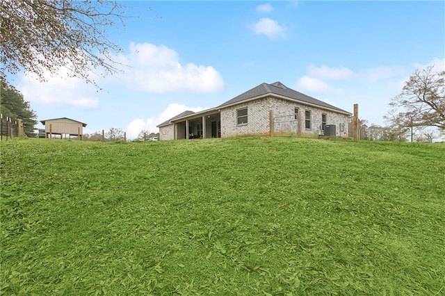 71078 Troy Spears Rd, Kentwood, LA 70444 - view of side of property featuring central air condition unit, a lawn, and brick siding