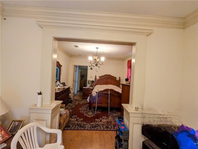 bedroom with crown molding, a notable chandelier, and dark hardwood / wood-style flooring