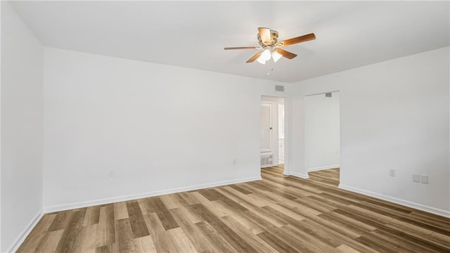 unfurnished room with ceiling fan and light hardwood / wood-style floors