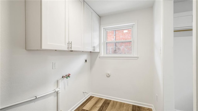 washroom with gas dryer hookup, hardwood / wood-style floors, cabinets, hookup for a washing machine, and electric dryer hookup