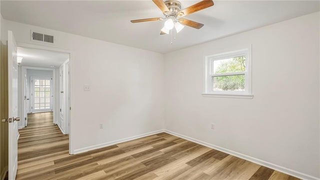 empty room featuring ceiling fan and hardwood / wood-style floors