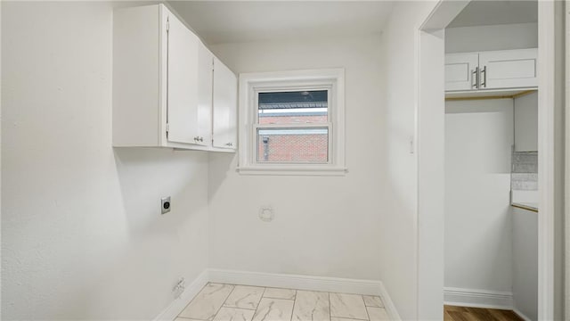 clothes washing area with cabinets and electric dryer hookup