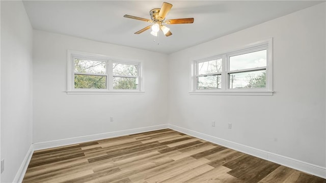 empty room with ceiling fan and light wood-type flooring