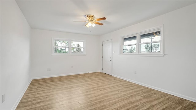 empty room with ceiling fan and light wood-type flooring