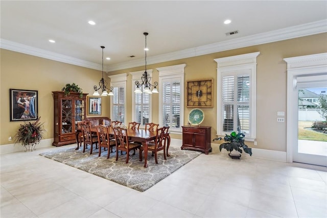 tiled dining room featuring an inviting chandelier and crown molding