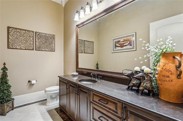 bathroom with tile patterned flooring, vanity, and toilet