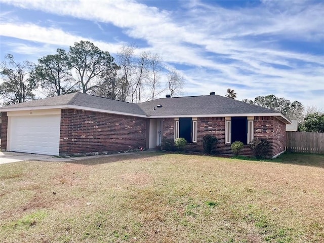 ranch-style house featuring a garage and a front lawn