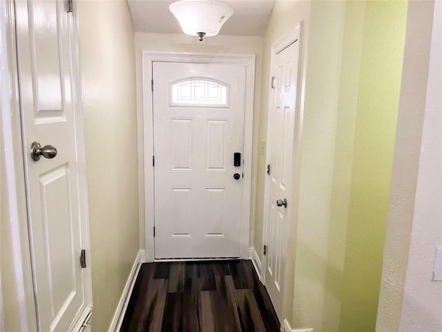 entryway with dark hardwood / wood-style flooring