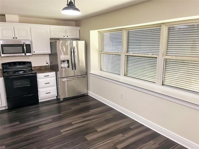 kitchen with stainless steel appliances, dark hardwood / wood-style floors, pendant lighting, and white cabinets