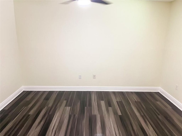 unfurnished room featuring dark wood-type flooring