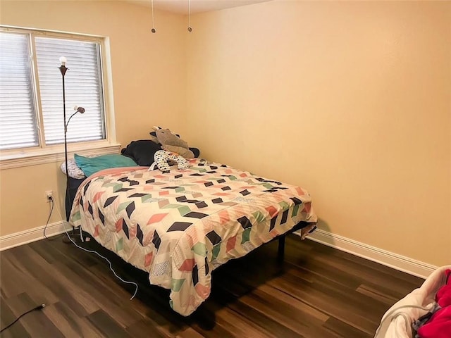 bedroom with dark hardwood / wood-style flooring