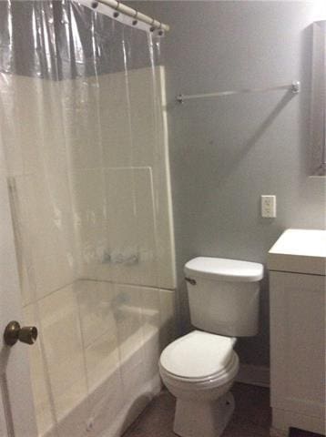 full bathroom with shower / tub combo, vanity, and toilet