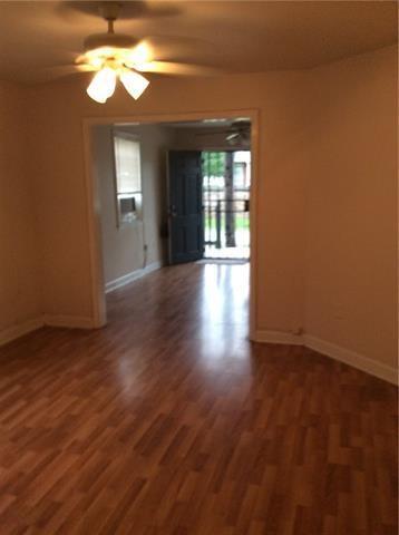 empty room featuring ceiling fan and dark hardwood / wood-style floors