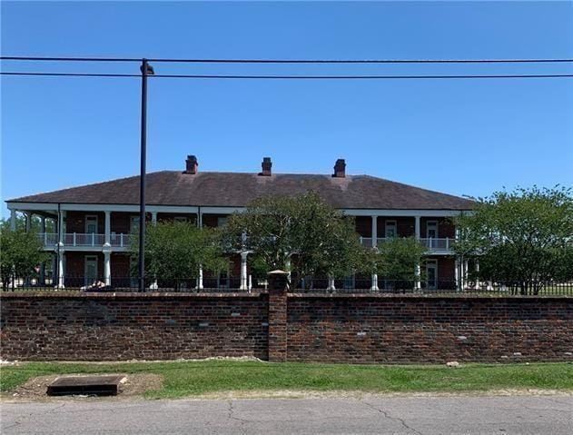 716-718 Delery St, New Orleans, LA 70117 - view of front of home with a chimney and fence
