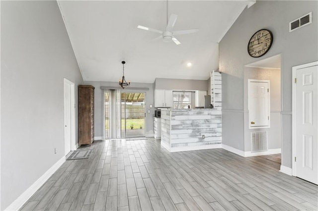 unfurnished living room with ceiling fan, high vaulted ceiling, and light hardwood / wood-style floors