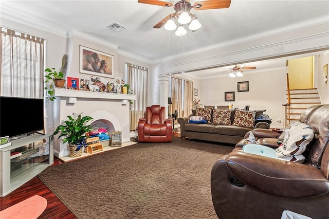 living room with hardwood / wood-style floors, crown molding, and ceiling fan