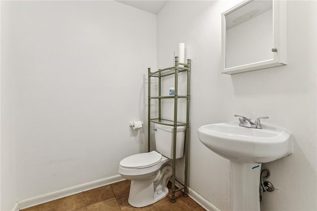 bathroom with sink, tile patterned floors, and toilet