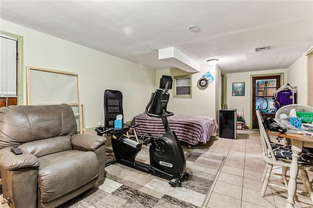 workout area featuring light tile patterned flooring