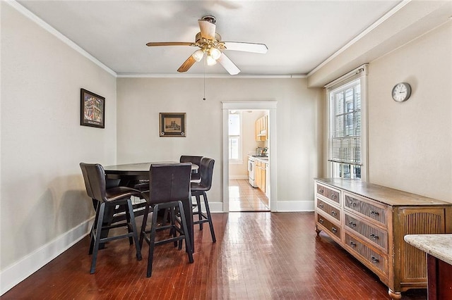 dining room featuring ornamental molding, plenty of natural light, and dark hardwood / wood-style floors